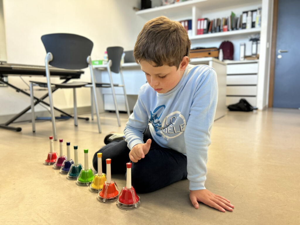 Boy playing with bells - music therapy