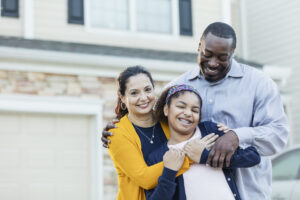 Parents hugging daughter
