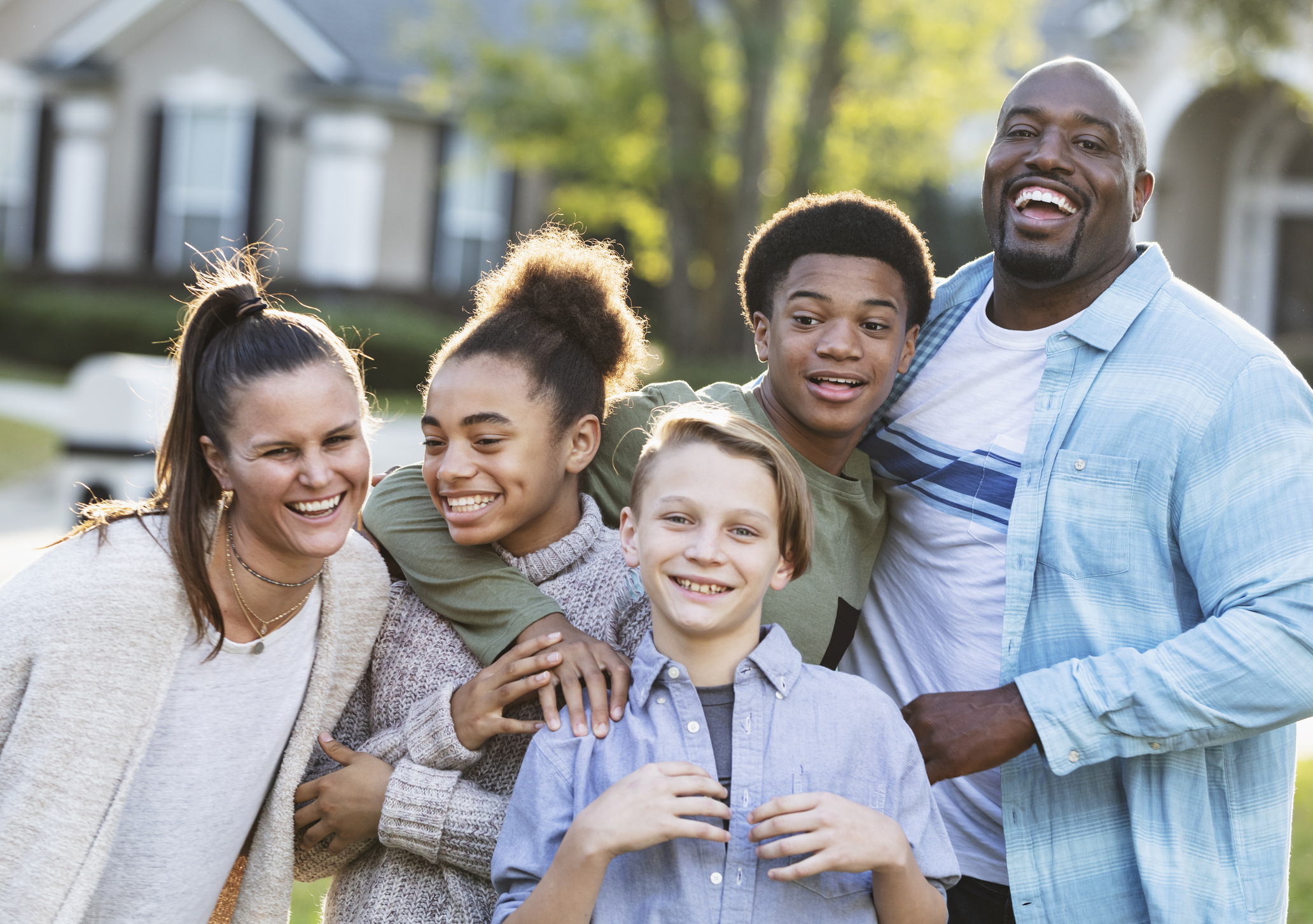 Happy family standing outside 