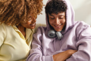 Mother and teenage son smiling.