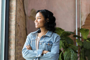 Young adult looks out the window.
