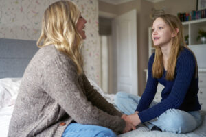 Emergency foster parent talking to teen girl