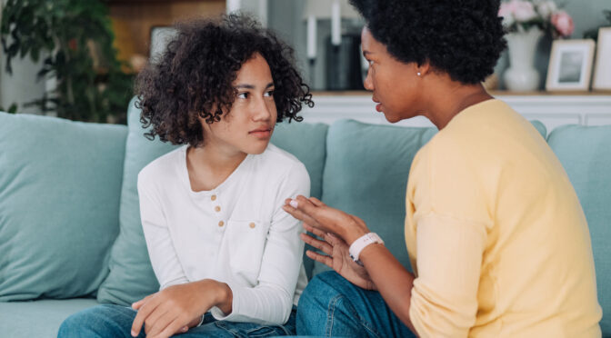 Mother and son talking about Seasonal Affective Disorder at home.
