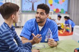 Missouri nurse working one-on-one with a young boy.