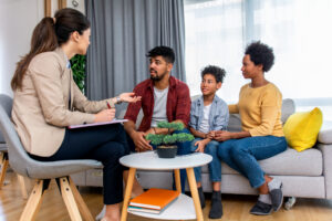 A family works together with a Wraparound Facilitator to create a personalized plan for their child’s wellbeing.