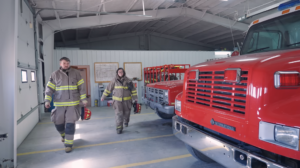 Atheah and Brayton Erickson wearing firefighter gear